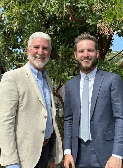 Chiropractors Christopher Tabick And Foote smiling outside.