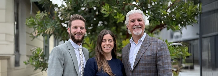 Christopher Tabick, Chase Foote, and Katie Outside Smiling inviting patients to contact